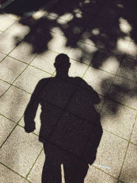 Shadow of person on footpath