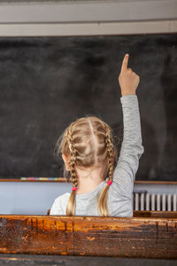 Portrait of woman with arms raised