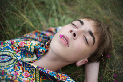 High angle view of man lying on grassy land