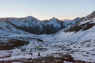 Scenic view of snowcapped mountains against clear sky