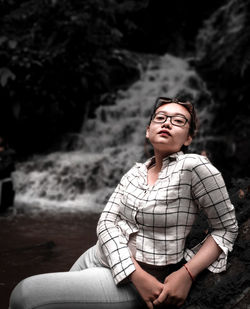 Portrait of smiling young woman sitting outdoors