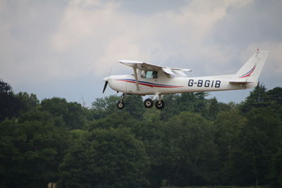 Low angle view of airplane flying against sky