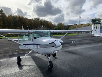 Airplane on runway against sky