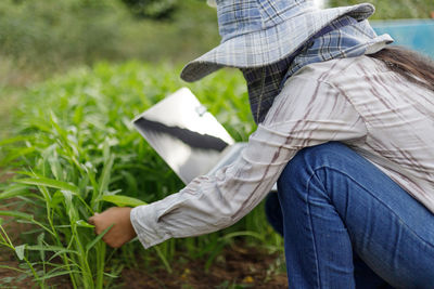 Low section of woman on field