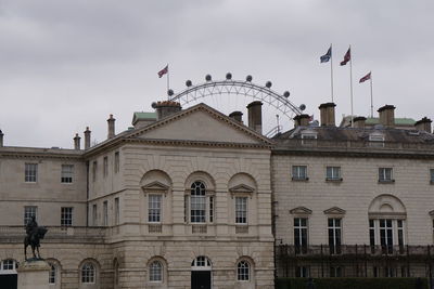 Low angle view of building against cloudy sky