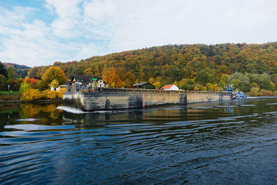 Scenic view of lake by autumn trees against sky