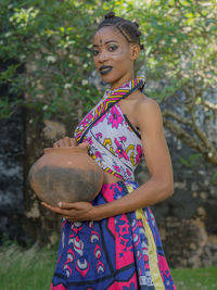 Close-up of girl holding plant