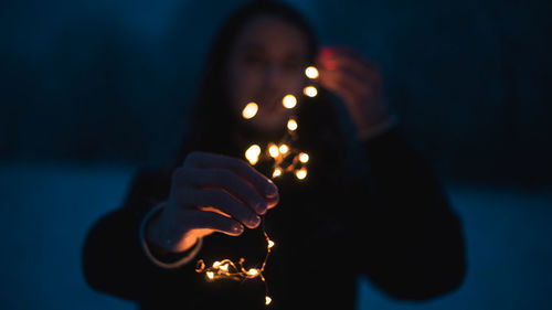 Man holding illuminated lighting equipment