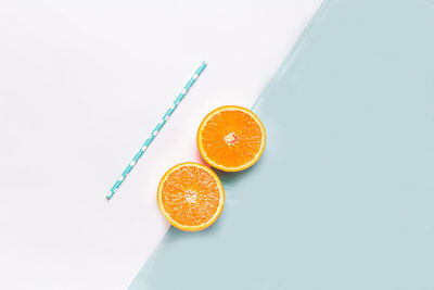 High angle view of orange fruit against white background