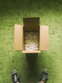 Low section of man standing by box