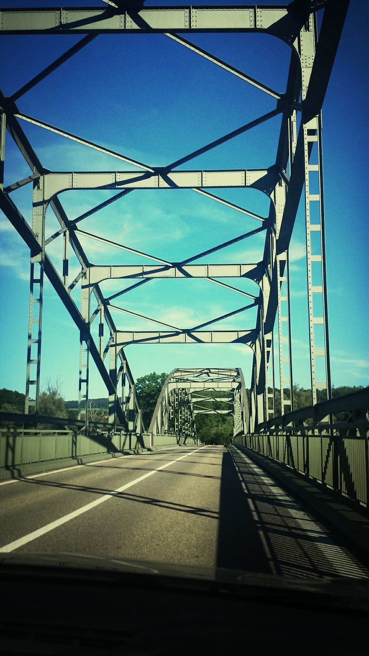 transportation, the way forward, built structure, connection, architecture, bridge - man made structure, diminishing perspective, railing, sky, vanishing point, clear sky, engineering, road, bridge, long, blue, sunlight, road marking, day, mode of transport