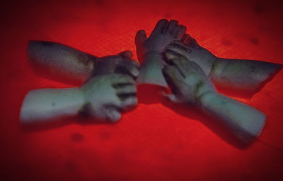 Close-up of hand on red wall