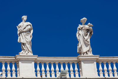 Low angle view of statue against blue sky