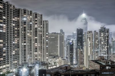 Illuminated cityscape against sky