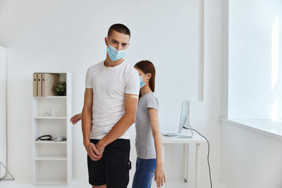 Young couple standing at home