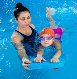 Portrait of boy swimming in pool