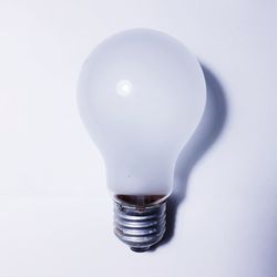 Close-up of light bulb against white background