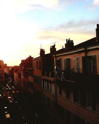 Buildings in city at sunset