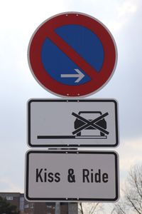 Low angle view of road sign against sky