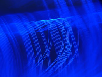 Close-up of illuminated light over blue background