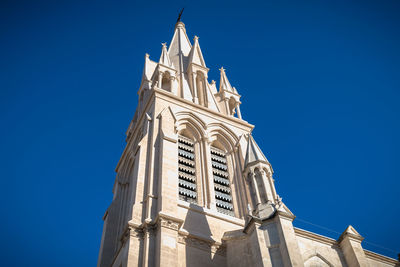 Low angle view of building against clear blue sky