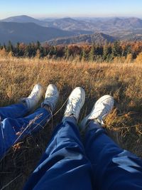 Persons on field with stunning mountain view 