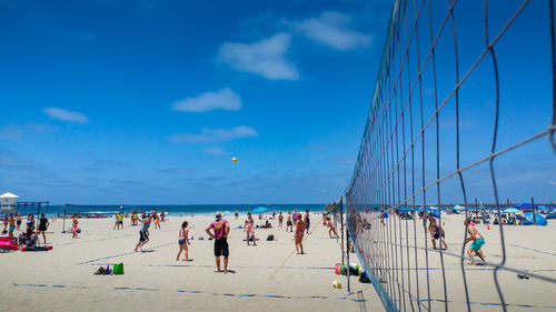 Close-up of volleyball people on at beach against sky