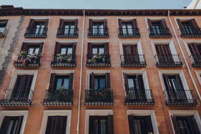 Facade of a traditional apartment block building in old town, madrid, spain, low angle view.