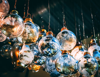 Low angle view of illuminated lanterns hanging from ceiling