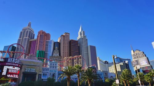 Low angle view of buildings against clear blue sky