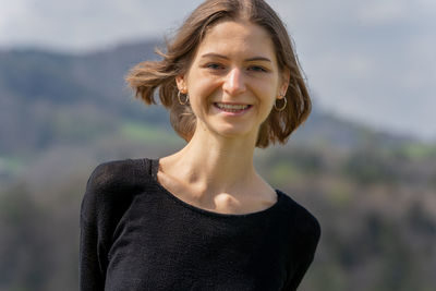 Portrait of young woman standing outdoors