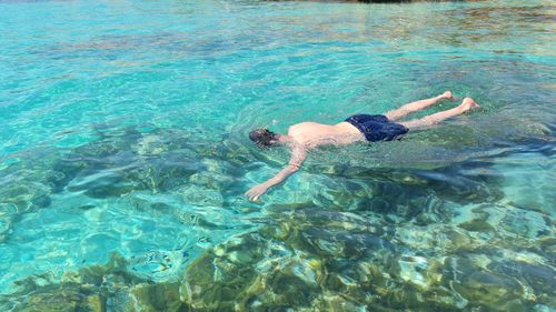 High angle view of man swimming in sea