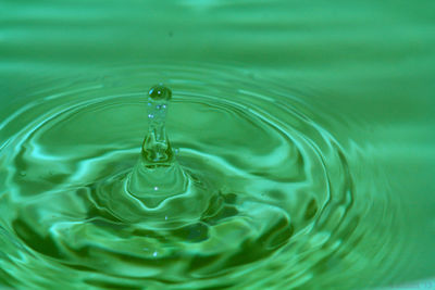 High angle view of drop falling in water