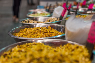 Close-up of spices in containers at market stall