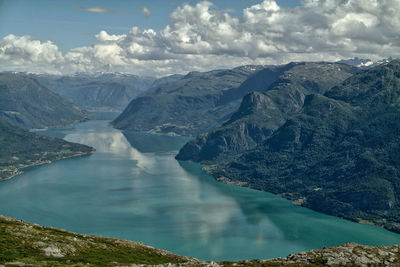 Scenic view of mountains against cloudy sky