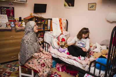 Mother and daughter in bedroom