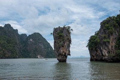 Scenic view of rock formation in sea against sky