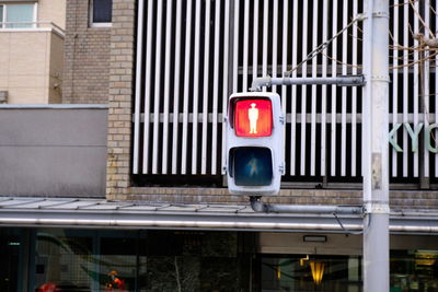 Stoplight against building in city