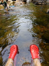 Low section of man with feet in water