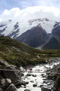 Scenic view of lake by mountains against sky