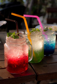 Close-up of cocktails in mason jars on table