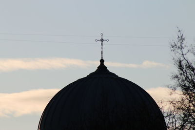 Low angle view of silhouette building against sky during sunset