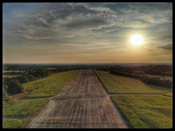 Scenic view of field against sky during sunset