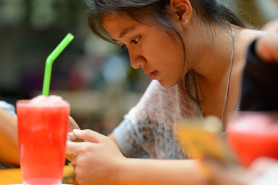 Close-up of woman drinking drink