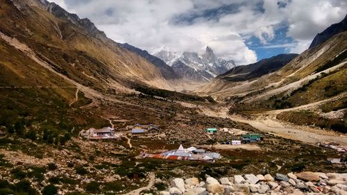 Scenic view of mountains against cloudy sky