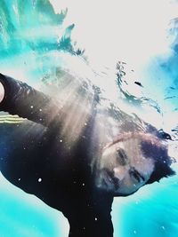 Portrait of young man swimming in sea