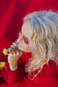 Portrait of woman holding red rose