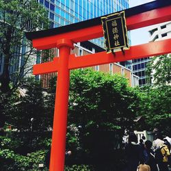 Low angle view of sign by building in city