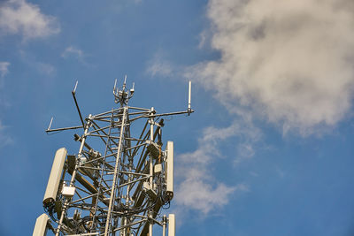 Low angle view of communications tower against sky