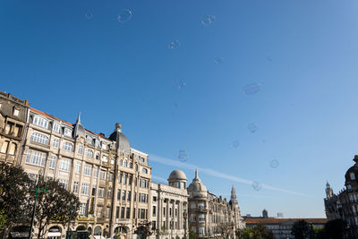 Low angle view of buildings against clear blue sky